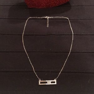 Silver tone necklace with 2 moving crystals.